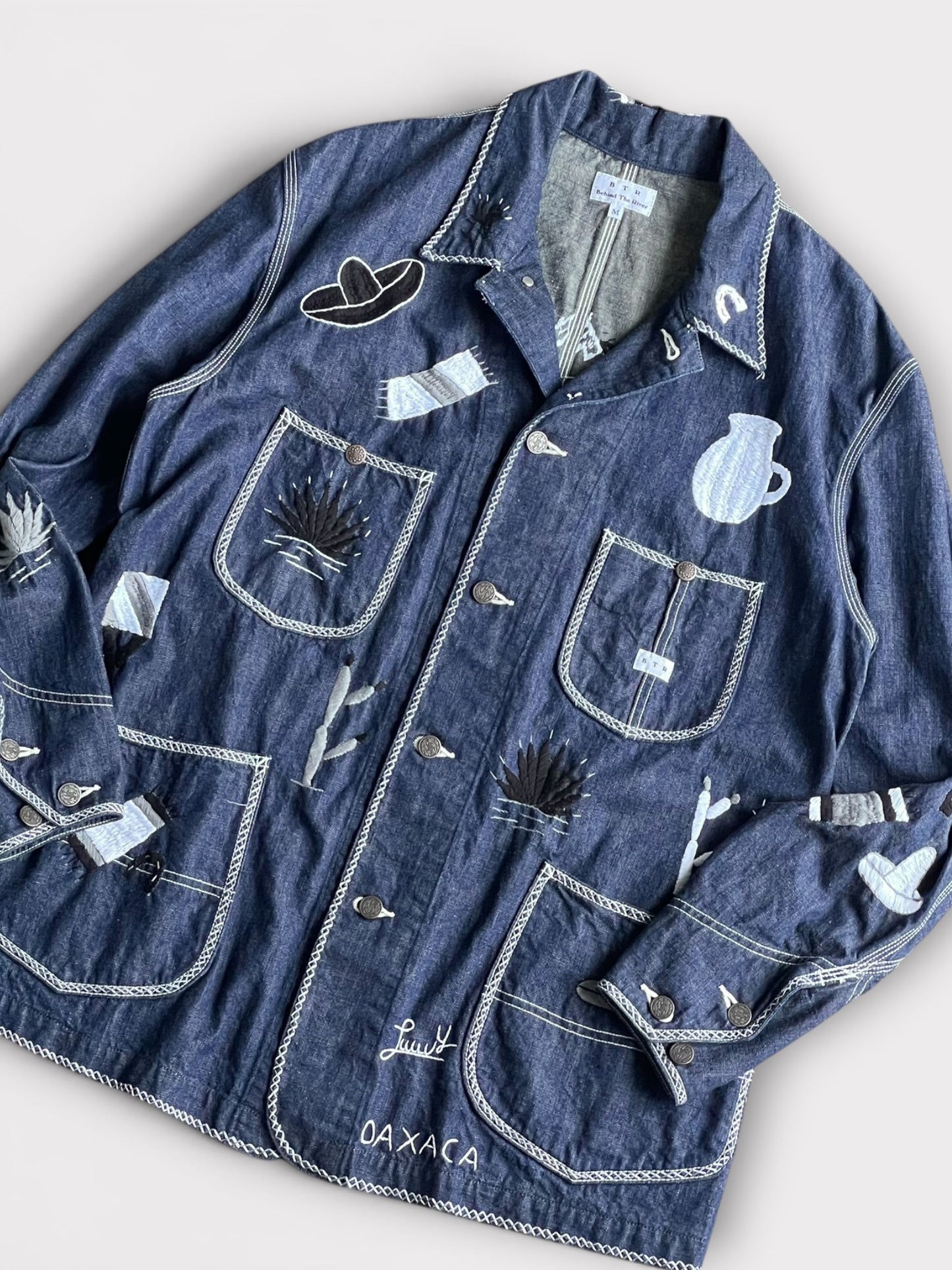 B T R × Lucy OAXACA Souvenir Coverall Jacket