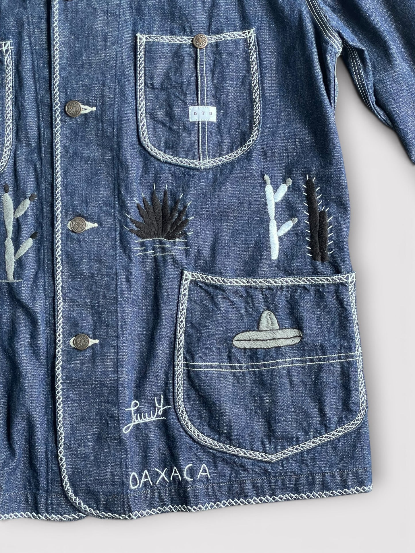 B T R × Lucy OAXACA Souvenir Coverall Jacket